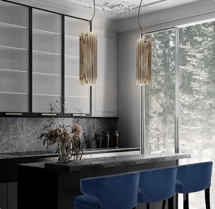 Luxury dark kitchen with marble island, blue velvet bar stools, and gold pendant lights